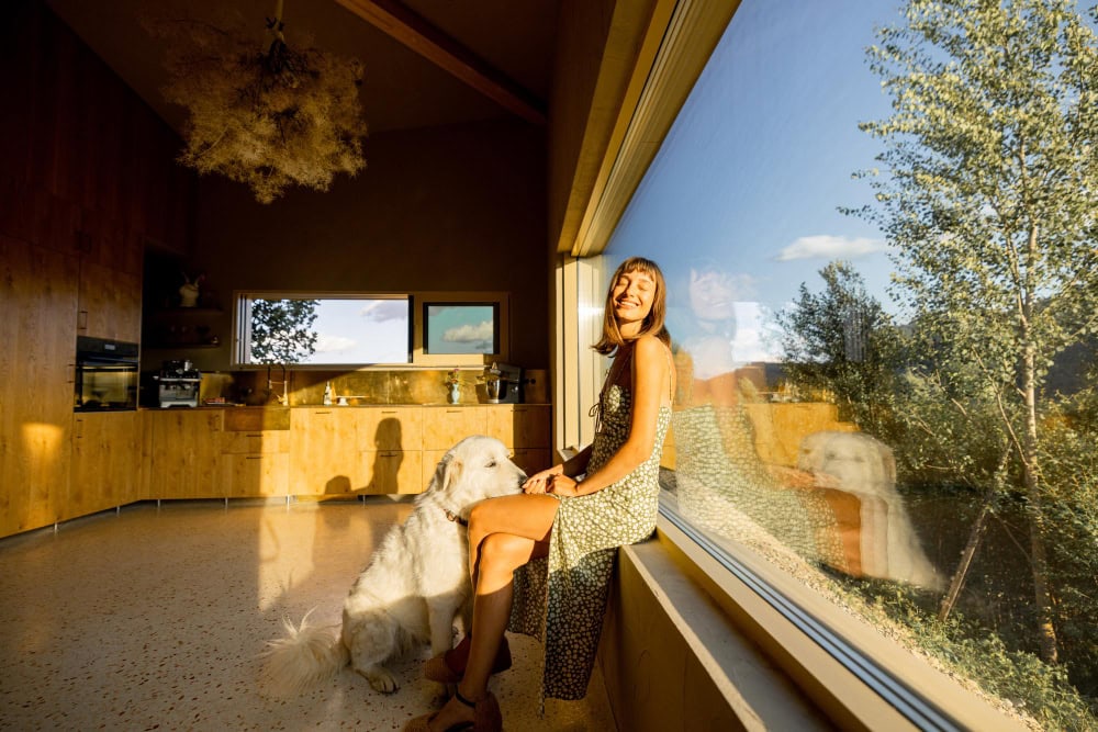 Woman sitting with a dog in an Eco home